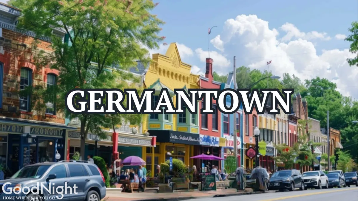 A lively street scene featuring colorful storefronts, people enjoying outdoor dining, green trees lining the sidewalk, and a cloudy blue sky overhead. The area exudes a welcoming, vibrant atmosphere that encourages exploration and leisurely strolls.